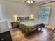 Well-lit bedroom with hardwood floors, neutral walls, and comfortable queen-sized bed at 2741 Fairlawn Dr, Columbus, IN 47203