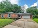 Charming brick home featuring a two-car garage, landscaped front yard, and inviting curb appeal at 2741 Fairlawn Dr, Columbus, IN 47203
