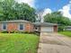 Charming brick home with manicured lawn, complemented by an attached two car garage at 2741 Fairlawn Dr, Columbus, IN 47203