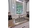 The kitchen sink sits beneath a window at 2741 Fairlawn Dr, Columbus, IN 47203
