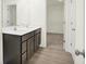 Modern bathroom featuring a double sink vanity, wood-look flooring, and doorway to closet at 2750 Glade Ave, Plainfield, IN 46168