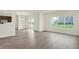 Bright, open-concept living space with laminate flooring and access to the kitchen at 2750 Glade Ave, Plainfield, IN 46168