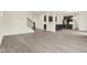 Open-concept living room featuring laminate flooring and an open staircase at 2750 Glade Ave, Plainfield, IN 46168