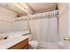 Well-lit bathroom with vanity, toilet, and shower with patterned curtain, offering functionality and comfort at 2916 Sunmeadow Way, Indianapolis, IN 46228