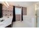Well-lit bathroom featuring double sinks, a tub, and decorative tiled accents at 2916 Sunmeadow Way, Indianapolis, IN 46228