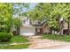 Inviting exterior of a brick and white home with a well-manicured lawn and mature trees at 2916 Sunmeadow Way, Indianapolis, IN 46228