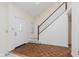 Bright foyer with wood-patterned flooring and a staircase leading to the upper level at 2916 Sunmeadow Way, Indianapolis, IN 46228