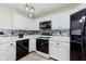 Modern kitchen featuring white cabinets, tile backsplash, stainless steel appliances, and stylish lighting at 2916 Sunmeadow Way, Indianapolis, IN 46228