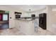 Well-lit kitchen featuring white cabinets, black appliances, and a breakfast bar at 2916 Sunmeadow Way, Indianapolis, IN 46228