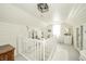 Upstairs landing with bright white color palette, unique decor, and a sunny window at 311 Northshore Blvd, Anderson, IN 46011