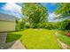 Well-manicured backyard with large green lawn and beautiful foliage around the house at 311 Northshore Blvd, Anderson, IN 46011