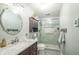 Updated bathroom with marble vanity, tile shower with glass door, and elegant fixtures at 311 Northshore Blvd, Anderson, IN 46011