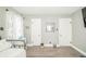 Bedroom with light gray walls and wood-look flooring with two doors, and bed in the foreground at 311 Northshore Blvd, Anderson, IN 46011