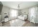 Bright bedroom featuring a daybed, wood laminate flooring, gray walls, and a chandelier at 311 Northshore Blvd, Anderson, IN 46011