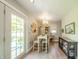Cozy dining area with modern light fixture, table set for four, and stylish wall decor at 311 Northshore Blvd, Anderson, IN 46011
