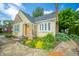Inviting yellow cottage-style home boasts stone detailing, neat landscaping, and a well-maintained exterior at 311 Northshore Blvd, Anderson, IN 46011