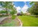 Expansive lawn and mature trees provide a picturesque setting for this charming residential property at 311 Northshore Blvd, Anderson, IN 46011