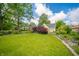 Serene lawn featuring flowers and plants, enhances the curb appeal of this charming residence at 311 Northshore Blvd, Anderson, IN 46011