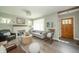 Inviting living space showcases a cozy fireplace, wood flooring, and an abundance of natural light at 311 Northshore Blvd, Anderson, IN 46011