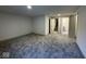 Unfinished basement space with new carpet, offering potential for customization and additional living space at 317 W Pierson St, Greenfield, IN 46140