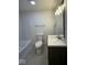 Cozy bathroom featuring tiled floors, tub, toilet, and dark vanity with sink at 317 W Pierson St, Greenfield, IN 46140