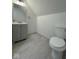Attic bathroom featuring a toilet and vanity, providing a functional and stylish space at 317 W Pierson St, Greenfield, IN 46140