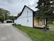 Side view of a two-story home, showcasing its mixed siding, clean lines, and a detached garage at 317 W Pierson St, Greenfield, IN 46140