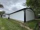 Long shot of a detached garage with a black door, showcasing the functional design and durable siding at 317 W Pierson St, Greenfield, IN 46140
