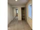 Hallway with neutral paint, tiled floors, closet with shelving, and exterior door with window at 317 W Pierson St, Greenfield, IN 46140