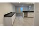 Spacious kitchen featuring dark countertops, white cabinets, and tile flooring at 317 W Pierson St, Greenfield, IN 46140