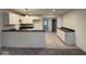 Contemporary kitchen featuring white cabinets, black countertops, and sleek flooring throughout the room at 317 W Pierson St, Greenfield, IN 46140