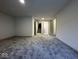 Spacious living room featuring neutral paint, carpet, and partial view of the stairs at 317 W Pierson St, Greenfield, IN 46140