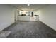 Bright living room boasts plush carpeting and neutral paint, flowing seamlessly to the kitchen at 317 W Pierson St, Greenfield, IN 46140