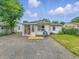 Backyard featuring a partially enclosed sunroom, a detached house, and green space at 3615 N Dequincy St, Indianapolis, IN 46218