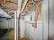 Utility basement with the main electrical panel, bare block walls, and other utility infrastructure at 3615 N Dequincy St, Indianapolis, IN 46218