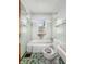 Bathroom with a toilet, tub, green tile and window, providing a cozy bathing experience at 3615 N Dequincy St, Indianapolis, IN 46218