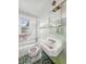 Bathroom featuring a toilet, sink, and bathtub with green tiling and natural light from a window at 3615 N Dequincy St, Indianapolis, IN 46218