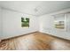 Empty bedroom showcasing hardwood floors and natural light, offering a blank canvas for personalization at 3615 N Dequincy St, Indianapolis, IN 46218