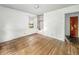 An empty bedroom featuring hardwood floors, closet, window, and white walls, ready for personalization at 3615 N Dequincy St, Indianapolis, IN 46218