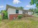 Charming single-story home featuring vinyl siding, and a brick foundation, surrounded by green landscaping at 3615 N Dequincy St, Indianapolis, IN 46218