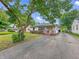 Cozy home with a lush front yard, sidewalk, and a driveway leading to a detached garage at 3615 N Dequincy St, Indianapolis, IN 46218