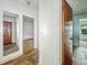 A hallway with peeling paint on the walls offers a glimpse of other rooms and their renovation potential at 3615 N Dequincy St, Indianapolis, IN 46218
