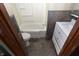 Small bathroom with a tub, toilet, and a white vanity with a mirror at 364 S Cole St, Indianapolis, IN 46241