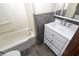 Cozy bathroom featuring a tub, toilet, and vanity with a sink and mirror at 364 S Cole St, Indianapolis, IN 46241