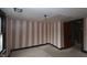 Bedroom featuring two windows and taupe and white striped wallpaper at 364 S Cole St, Indianapolis, IN 46241