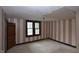 Stripped bedroom featuring two windows and taupe and white striped wallpaper at 364 S Cole St, Indianapolis, IN 46241
