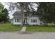 Charming two-story home with a covered front porch, mature trees, and tidy landscaping at 364 S Cole St, Indianapolis, IN 46241