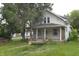 Charming two-story home with a covered porch and tree, displaying classic architectural details at 364 S Cole St, Indianapolis, IN 46241