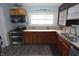 A kitchen featuring appliances, tile countertops, a window, and wood-look flooring at 364 S Cole St, Indianapolis, IN 46241