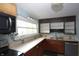 Kitchen featuring tile countertops, stainless steel appliances, and wood-look flooring at 364 S Cole St, Indianapolis, IN 46241